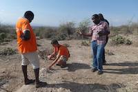 Geologist explaining the layer structure of Mirerani Hills, Tanzania